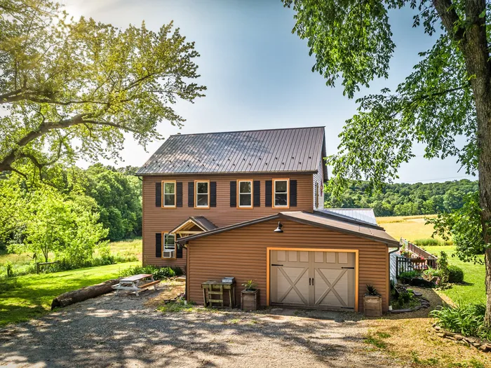 Bronze ABM panel roof & Mastic siding