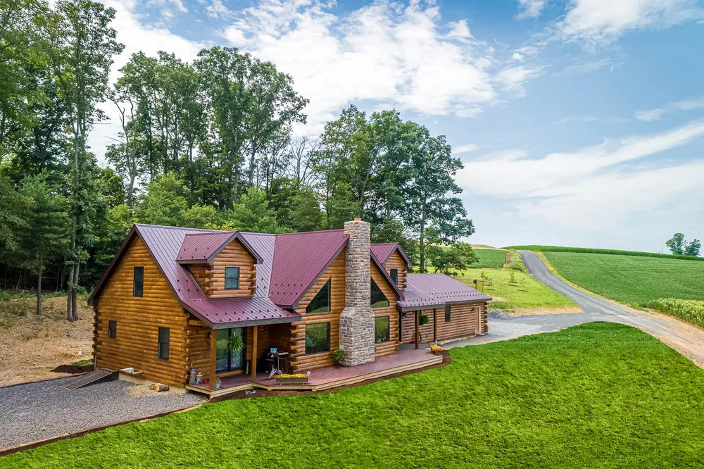 Log home with red standing-seam metal roof, photo 2