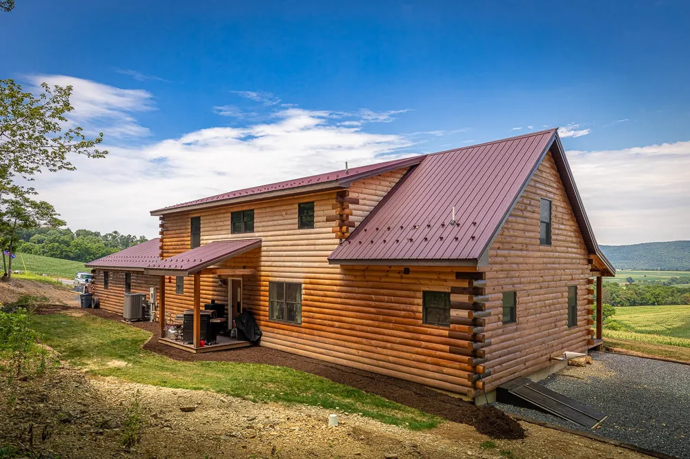 Log home with red standing-seam metal roof, photo 6