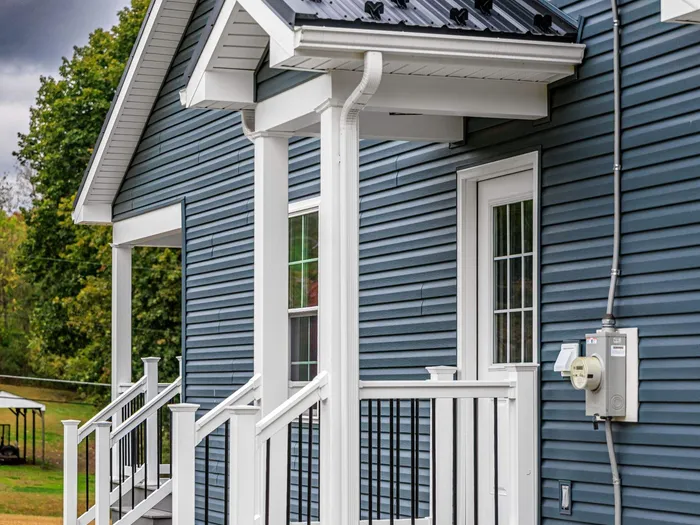 New Residential Addition with Blue Siding and Metal Roofing in Ashland