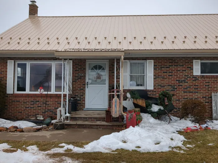 Tan Metal Roof and Gutter Replacement for Valley View Home